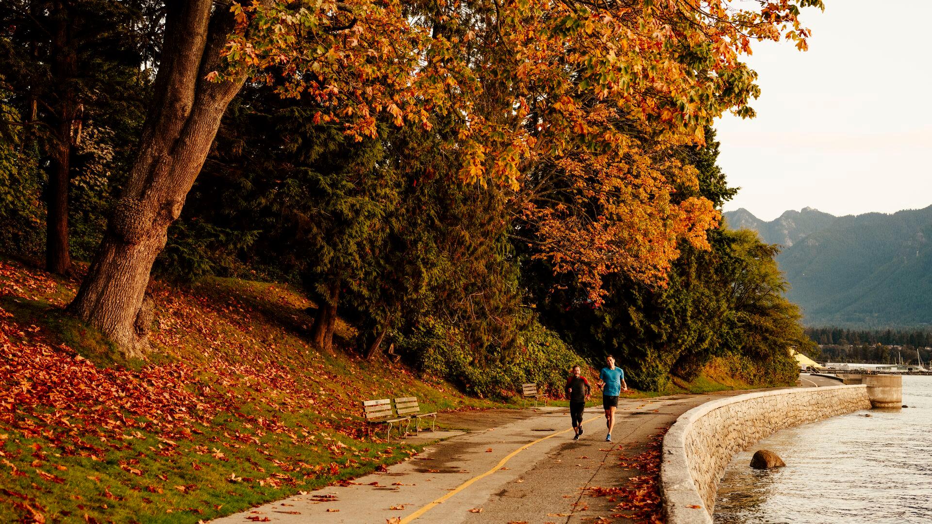 Joggers running along the Stanley Park seawall